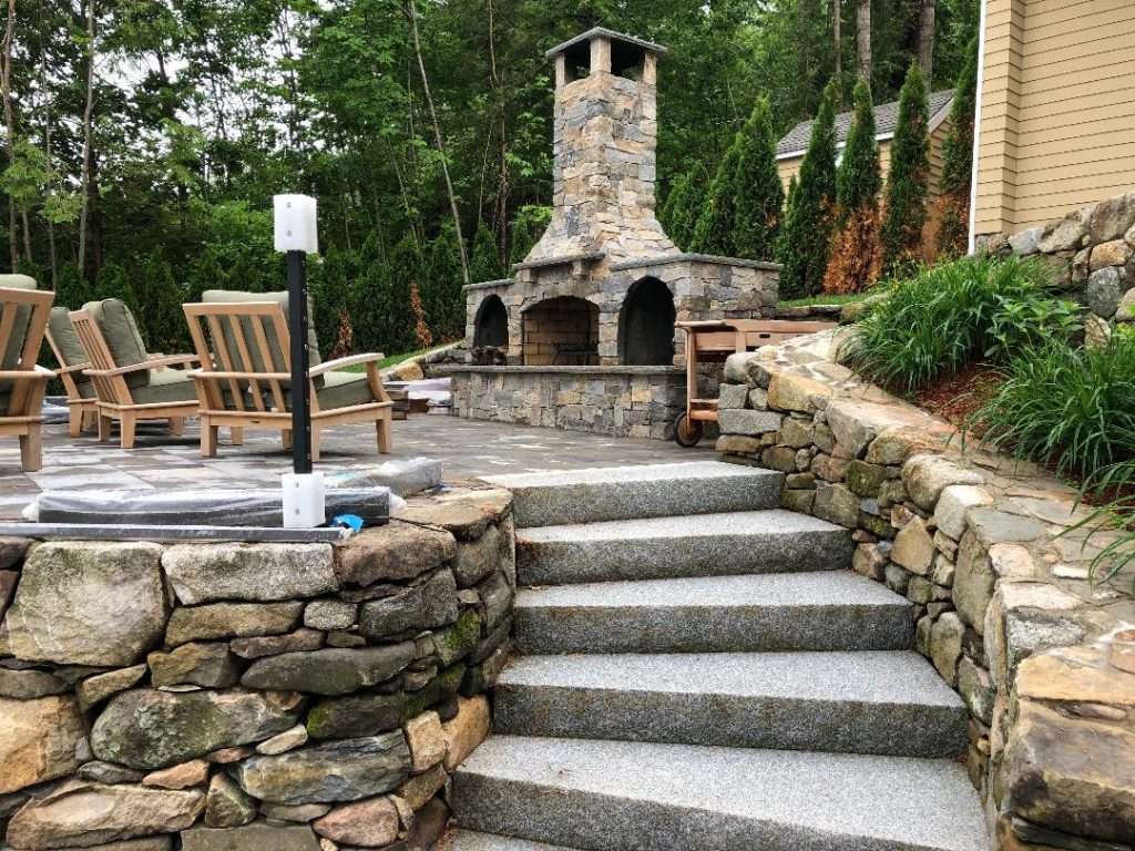 outdoor fireplace, stacked stone walls, stone patio and granite steps