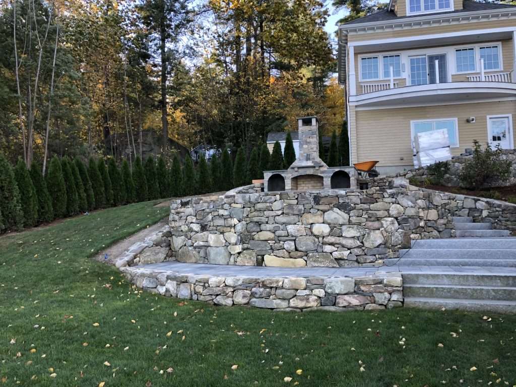 sloped terraced patio fireplace