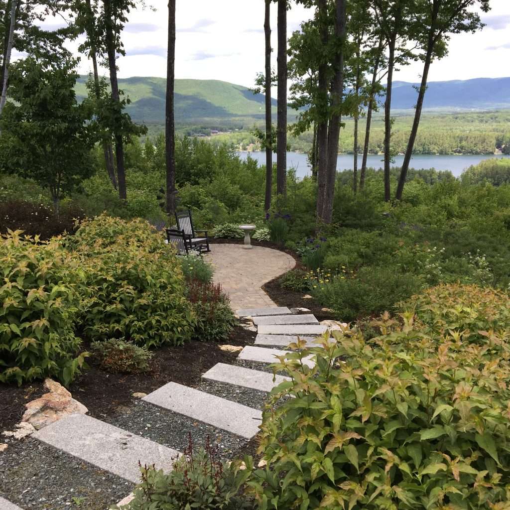 paver patio seating area with a lake view