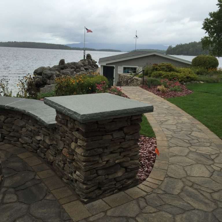 Guide to choosing landscaping materials featuring natural stone, pavers, granite, retaining wall options, mulch, and hardscape design inspiration for New Hampshire outdoor living projects by Landscapes by Tom